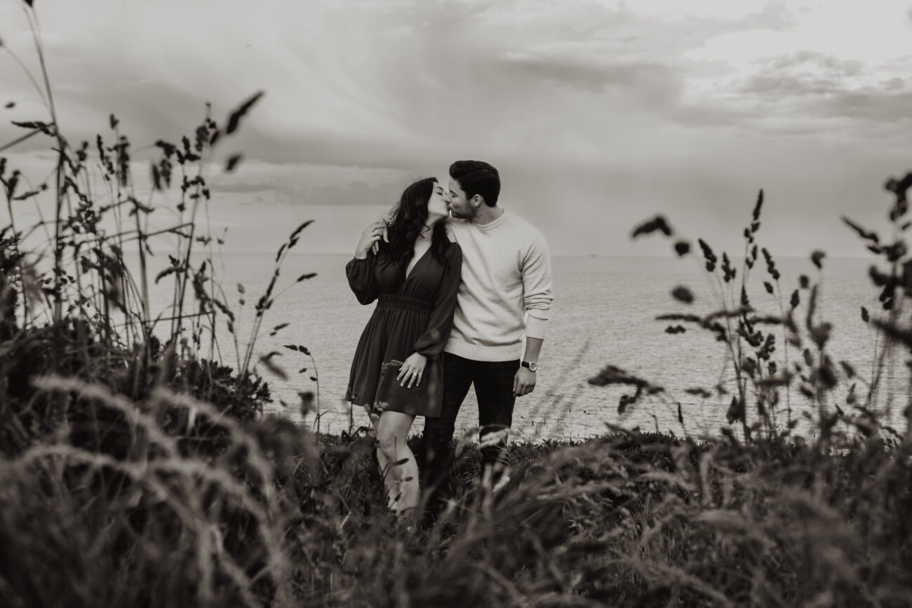 couple kissing on Howth Head. Secret proposal on the cliffs of Howth, Howth engagement shoot