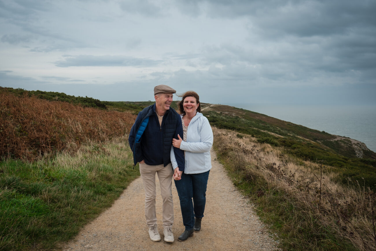 couple walking in Howth Summit on a rainy day and laughing