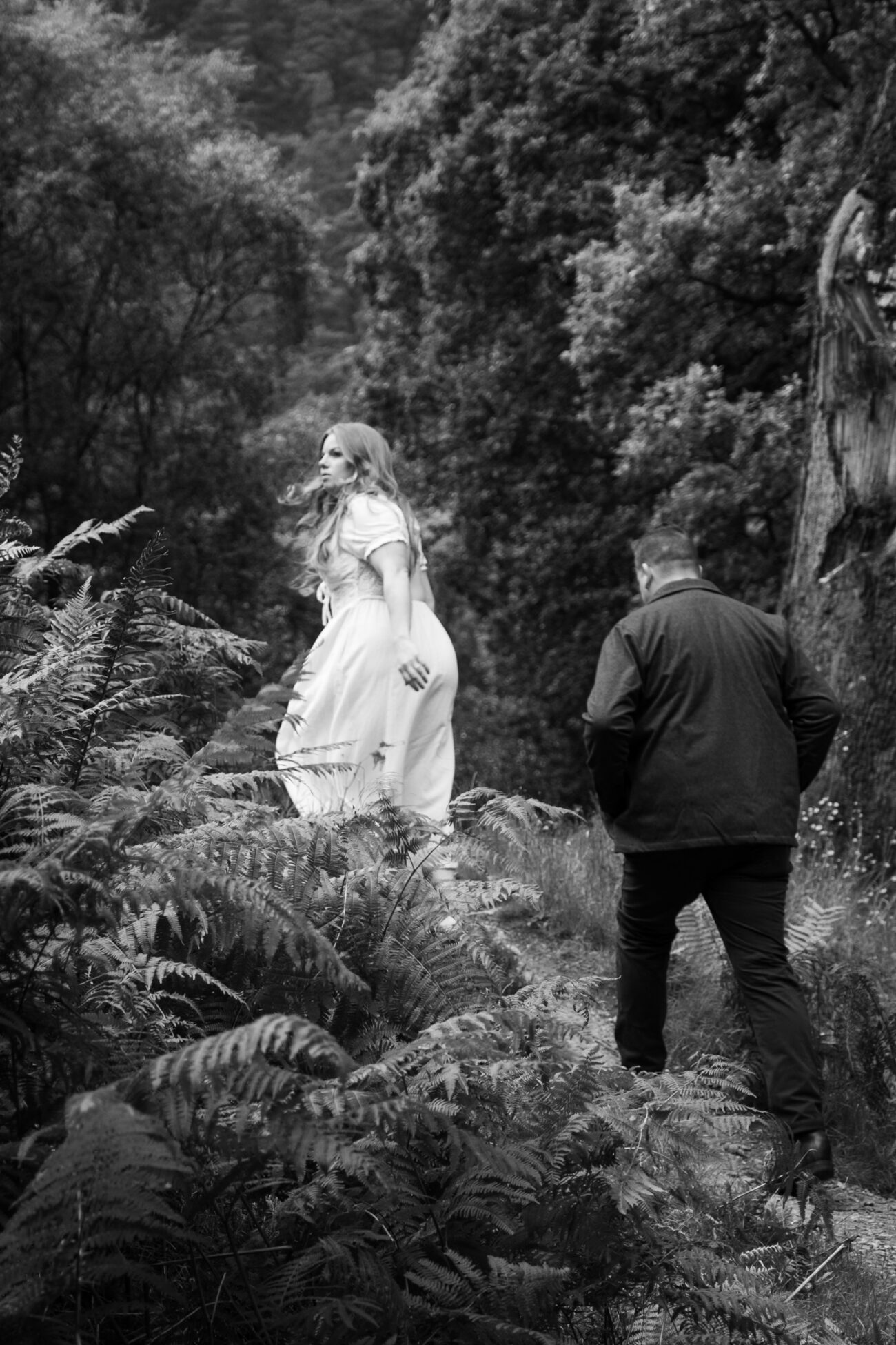 couple walking up the forrest in Glendalough