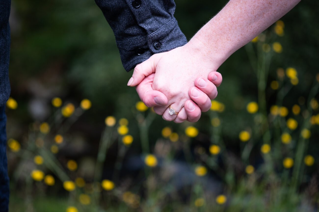 holding hands in the flowers at Glendalough