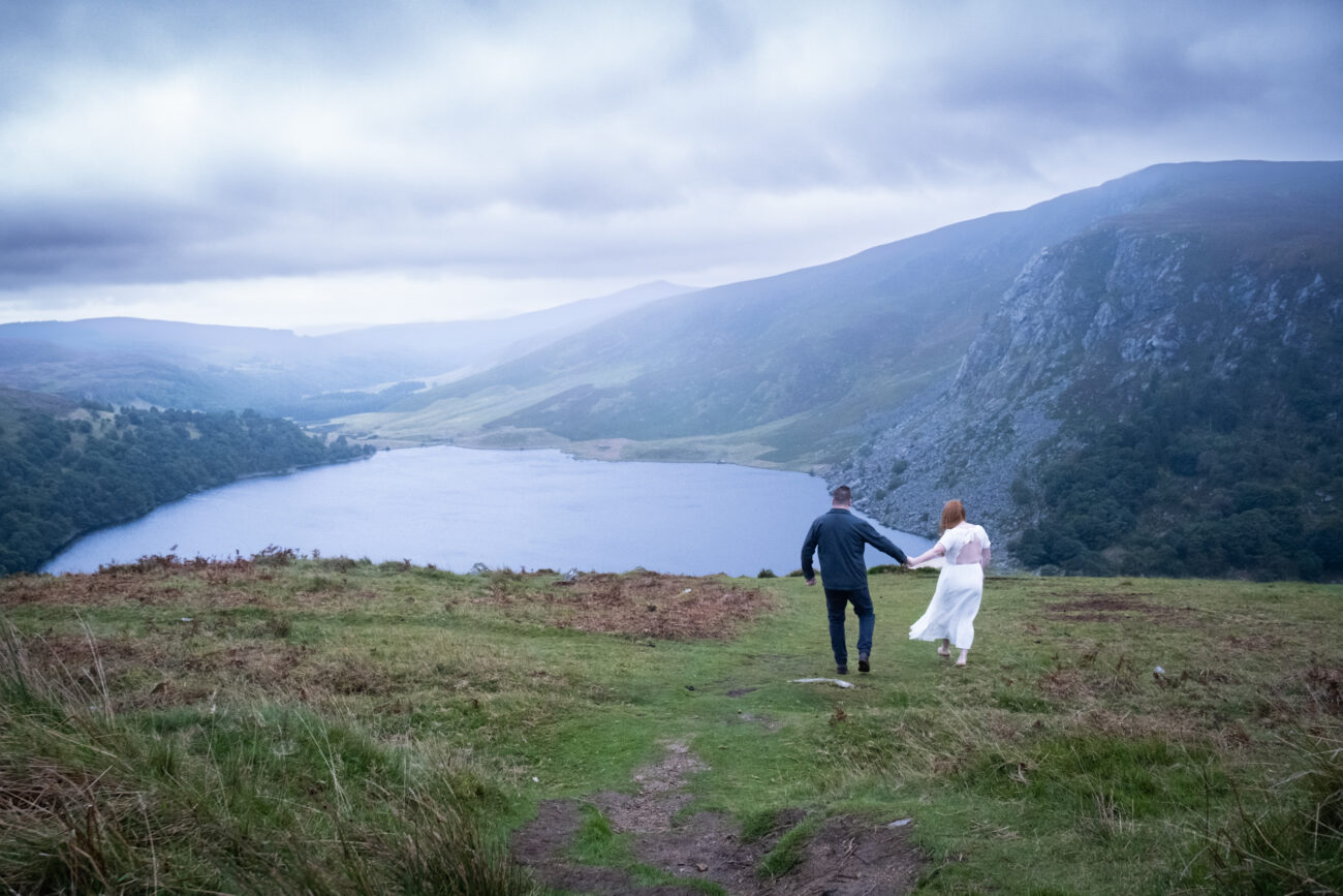 couple walking in the distance in Lough Tay