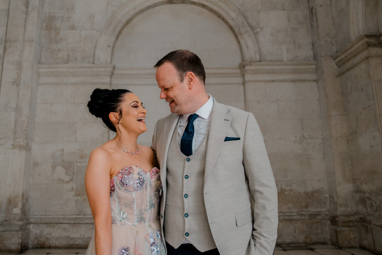 Couple facing each other and laughing at Dublin City Hall