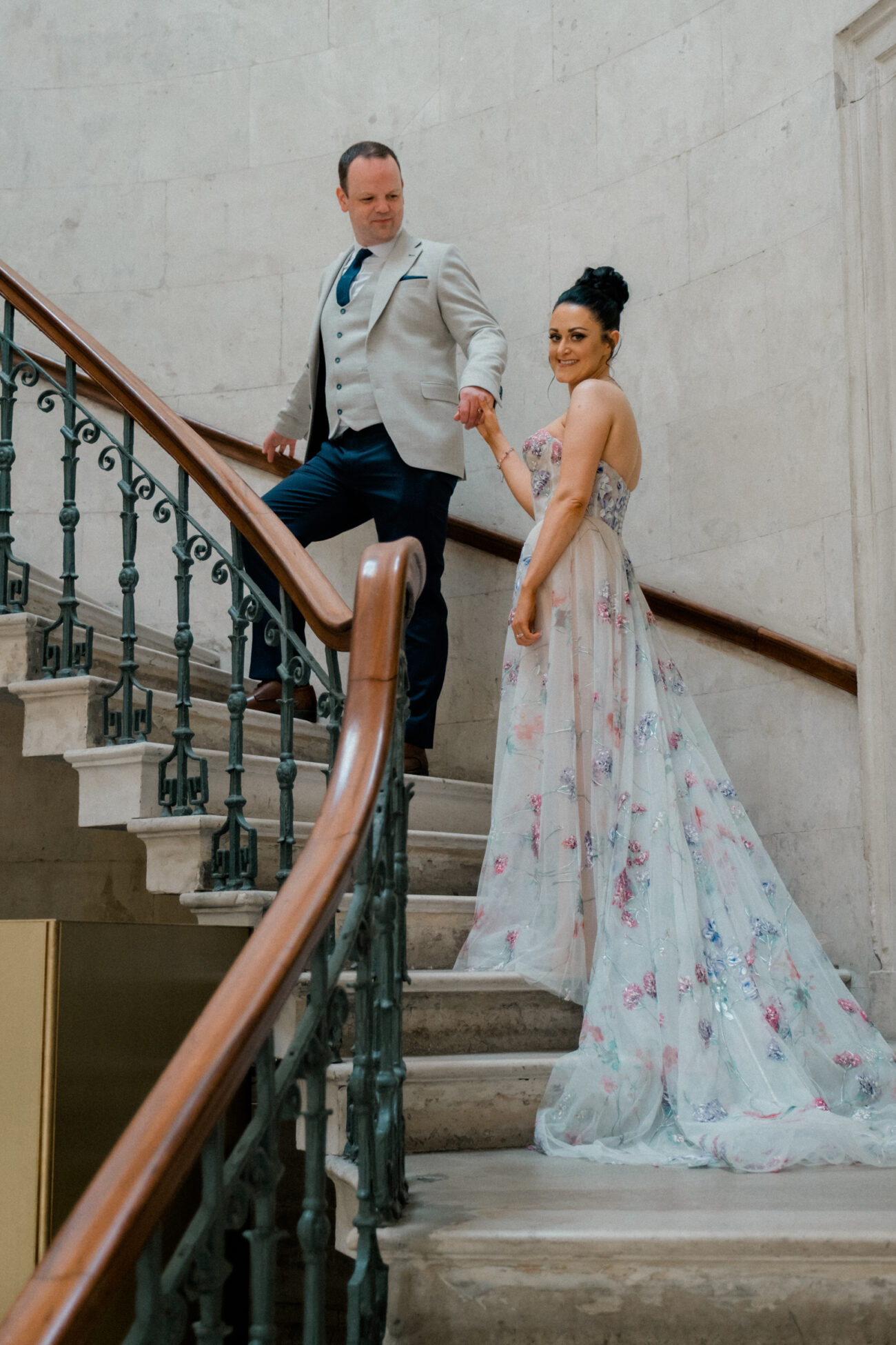 Couple walking up the stairs at Dublin City Hall wedding