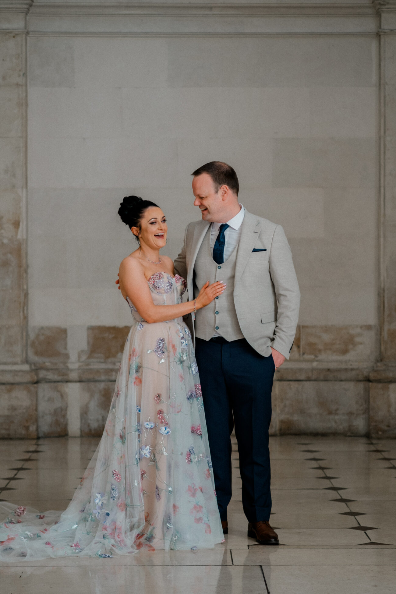 couple laughing at a pose in City Hall