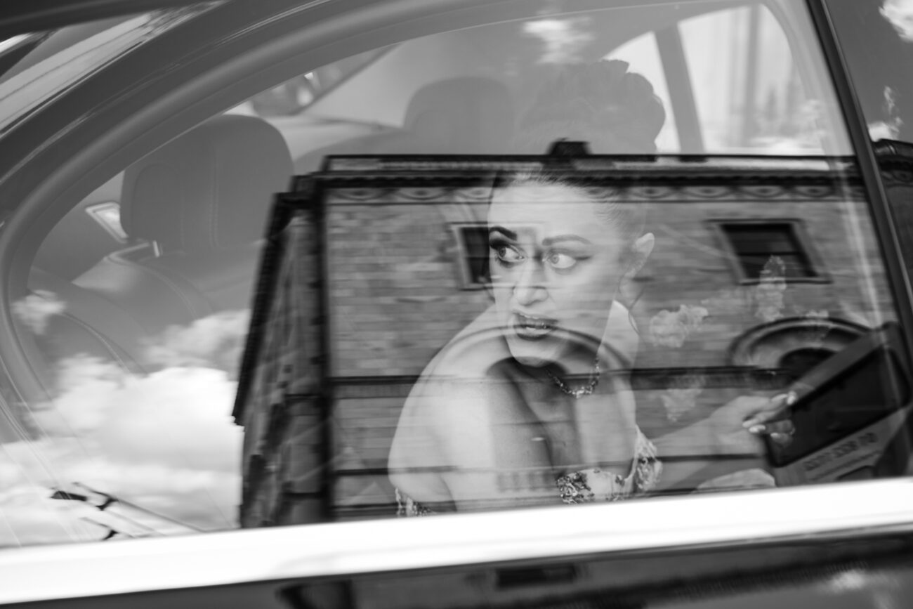 bride looking out the car window at Dublin City Hall
