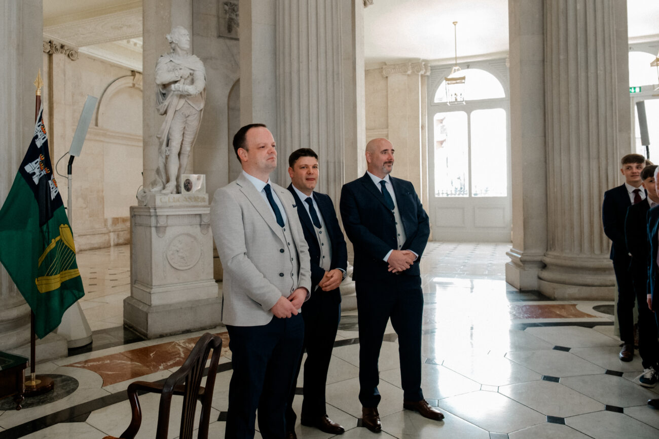 Groom looking at his bride walking down the aisle at Dublin City Hall