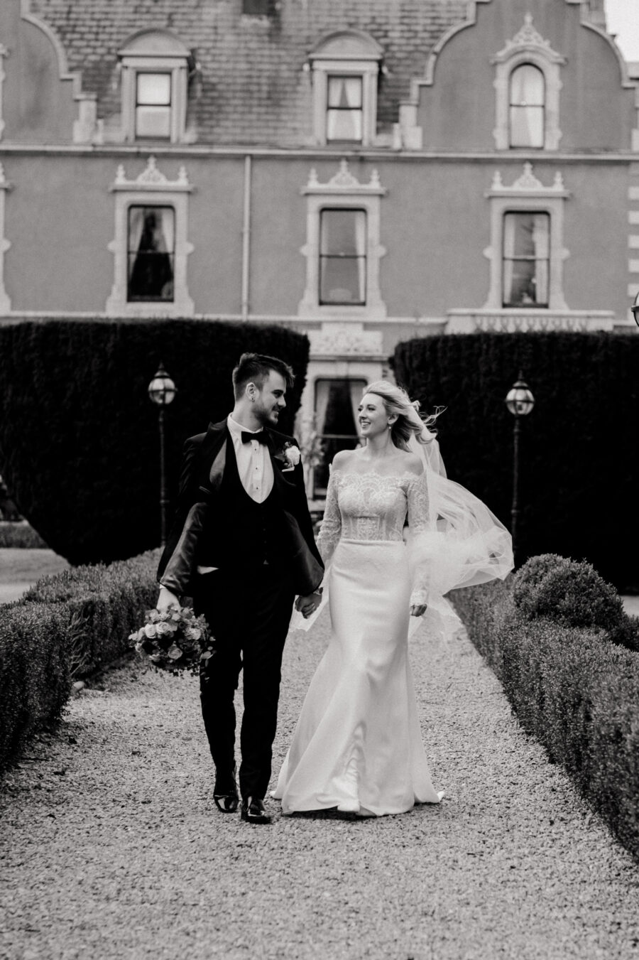Bride and groom waking down the garden together on the grounds of Killashee Hotel, Killashee Hotel wedding How to relax in front of the camera, candid wedding photographer in Dublin