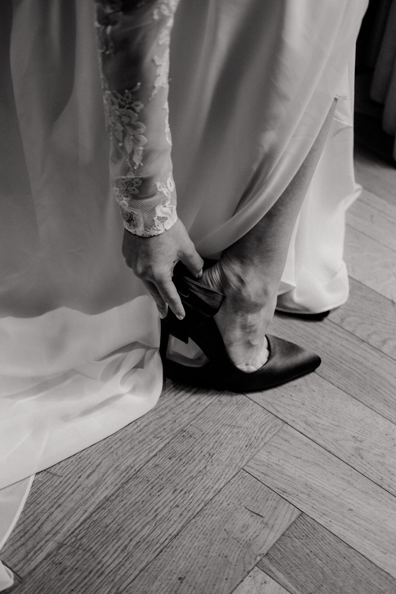 close up of bride putting on her shoe