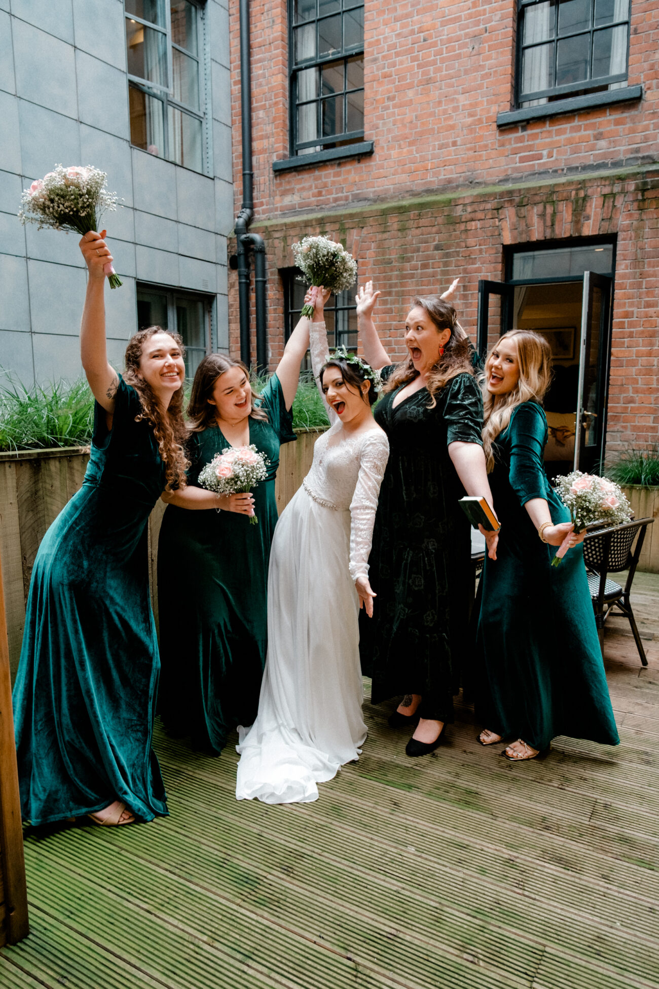 fun portrait of the bridesmaids and bride after getting ready