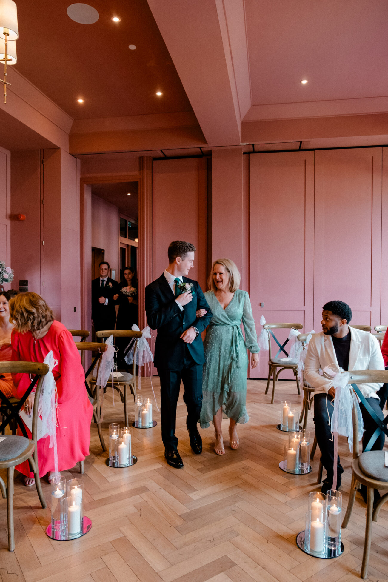 Groom walking down the aisle with his mum at The Clarence Hotel wedding. Dublin elopement