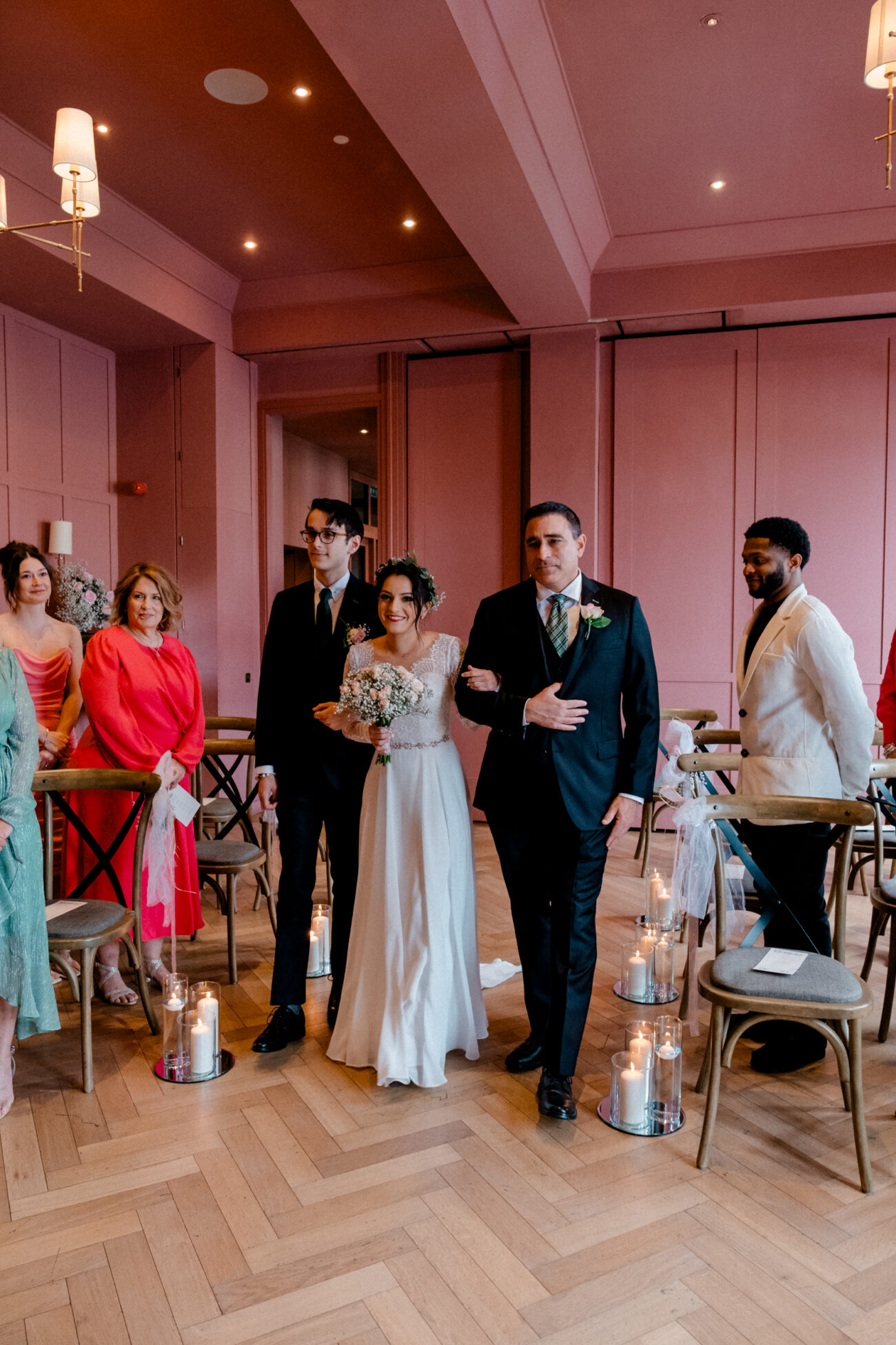 bride walking down the aisle with her father and brother at The Clarence hotel at a Dublin elopement