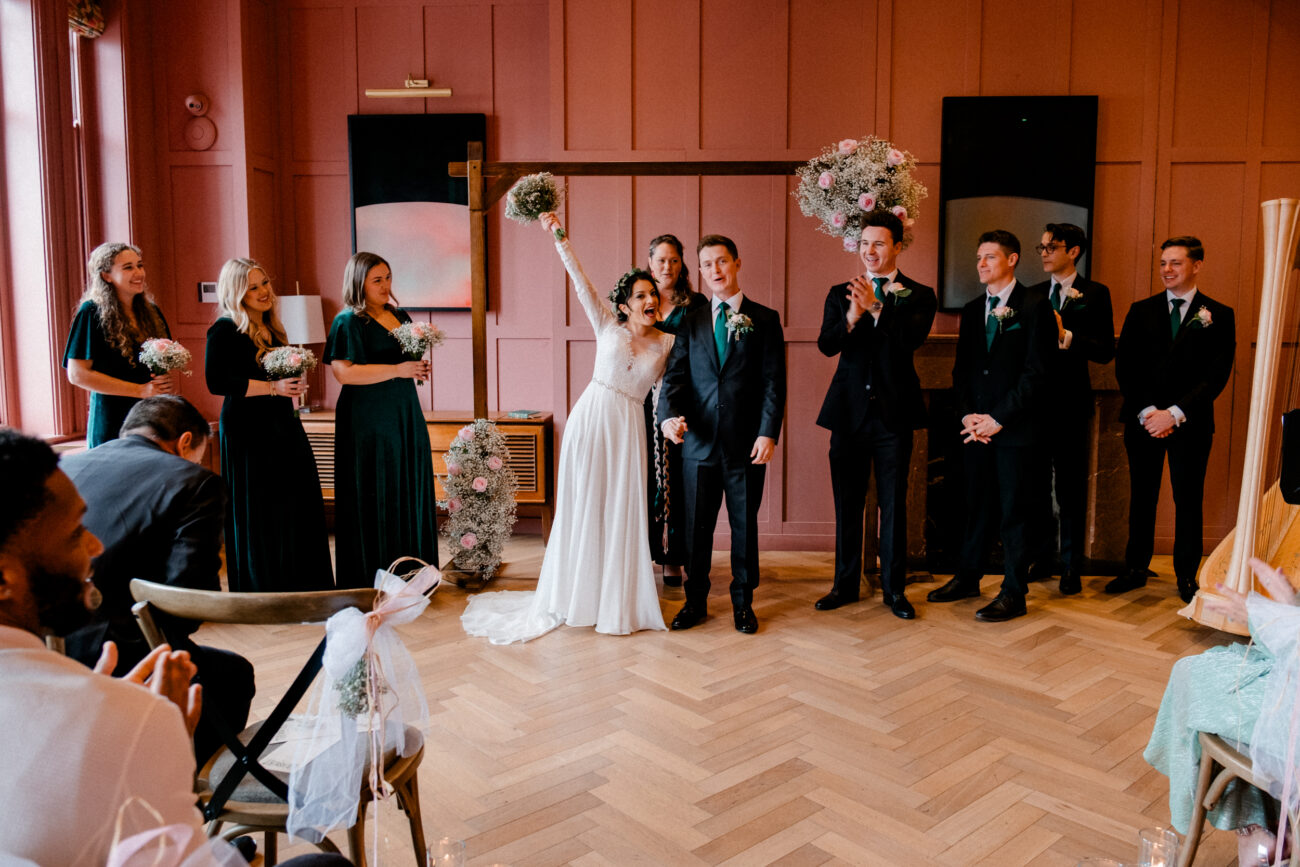 bride throwing bouquet up as a celebration in front of the crowd at The Clarence hotel wedding
