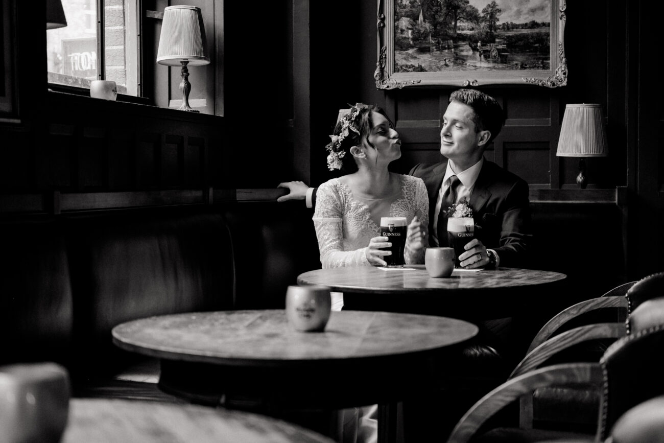 couple just drank a Guinness with froth on their lips. Clarence Hotel wedding