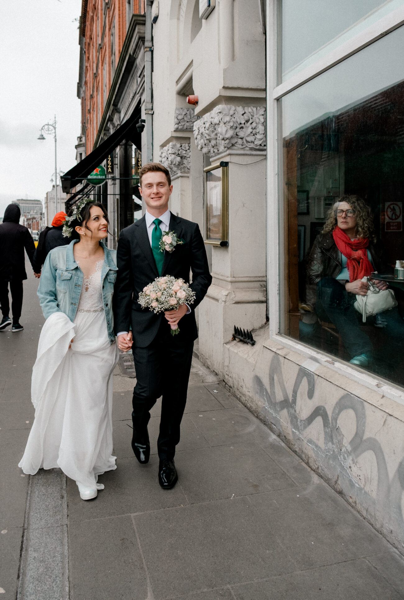 couple walking in the street of Dublin. Dublin elopement. Candid wedding portraits