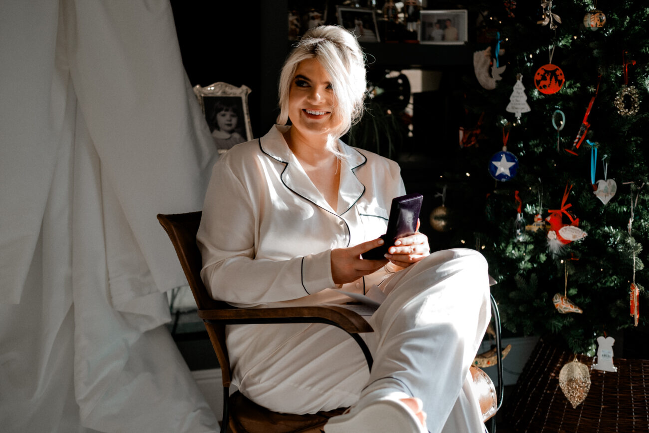 bride laughing whilst opening gifts. candid wedding photographer in Dublin
