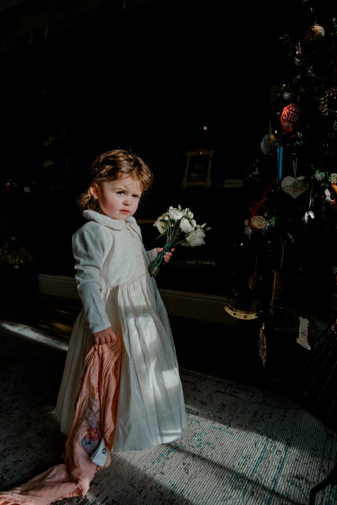 flowers girl standing next to the tree in the winter light