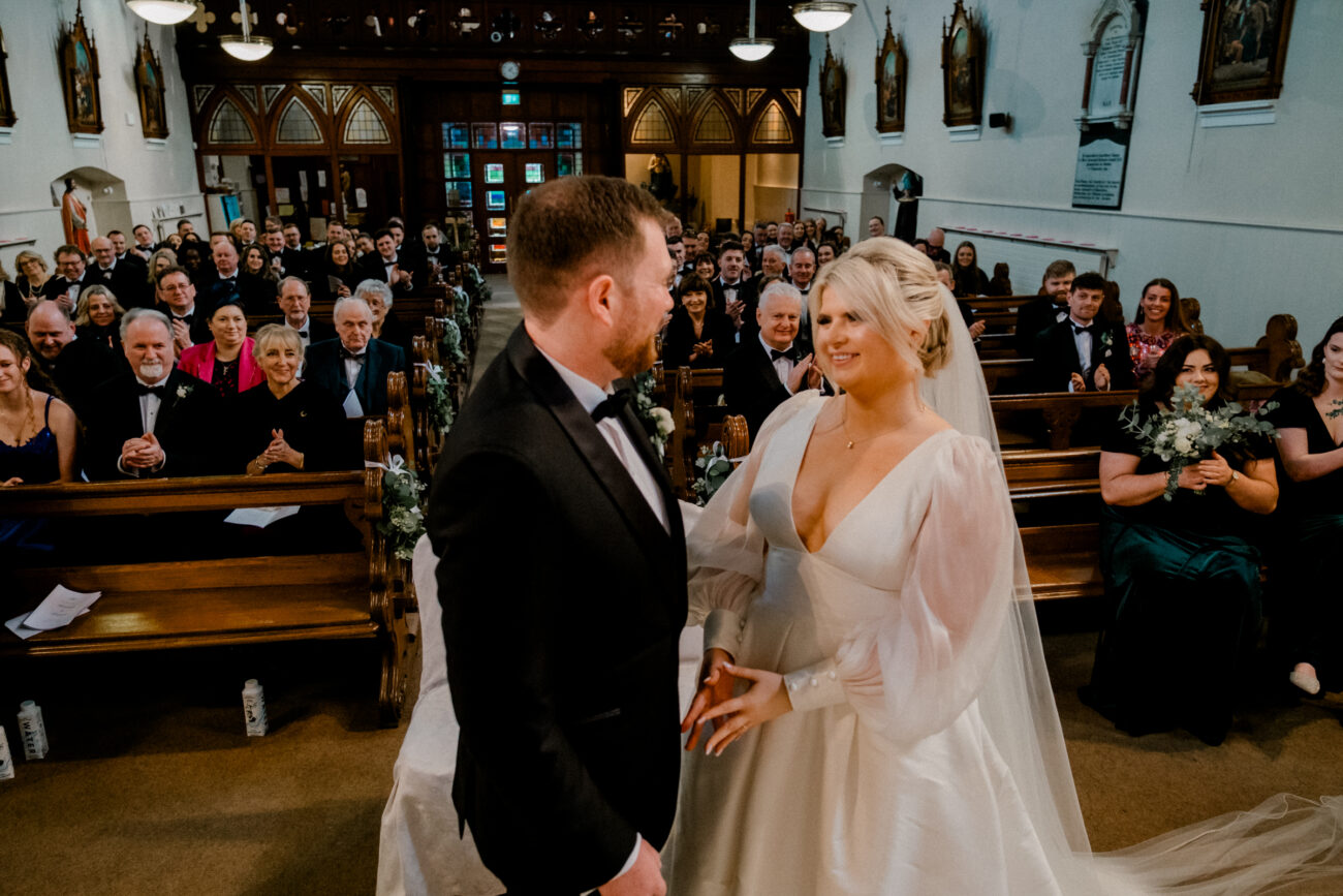 first kiss at the church. candid wedding moment