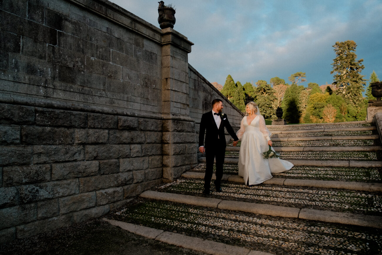 bride and groom walking down the steps in the gardens of Powerscourt Estate