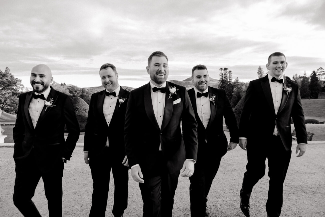 fun walking shot of the groom and his groomsmen at Powerscourt Estate