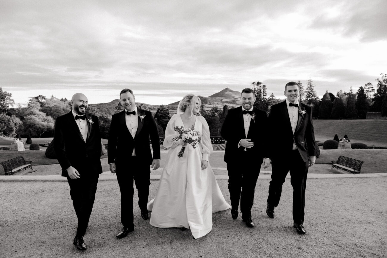 walking shot of the bride and the groomsmen at Powerscourt House