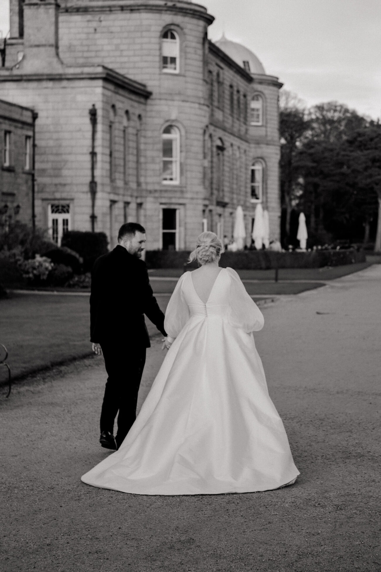 bride and groom walking back to the house at Powerscourt. candid wedding photography