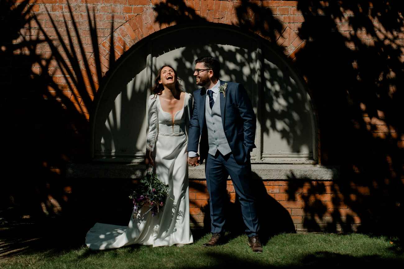 Couple laughing with each other during a portrait shoot at Portmarnock Hotel