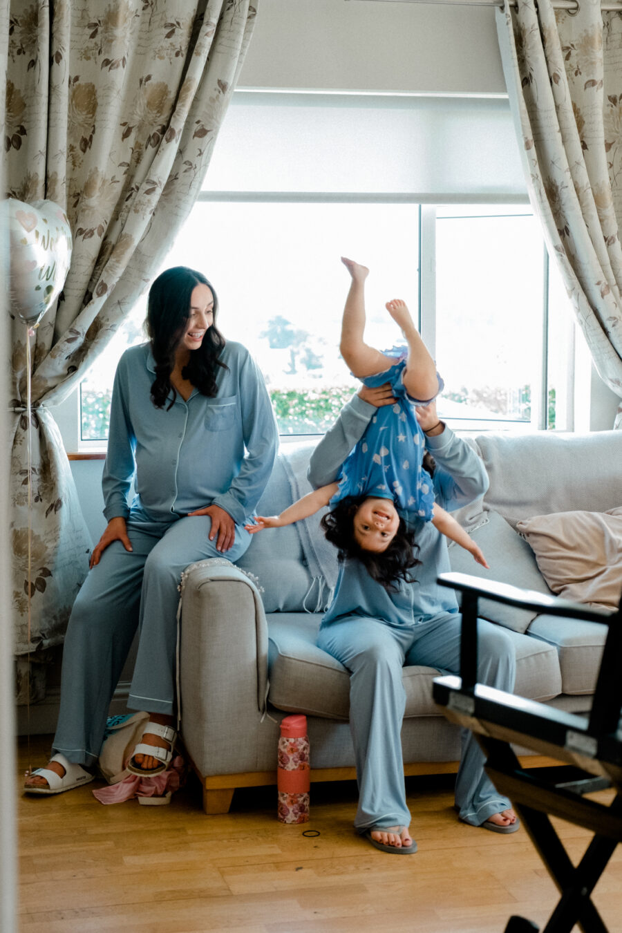 Bridesmaids having fun with the flower girl, candid wedding photography