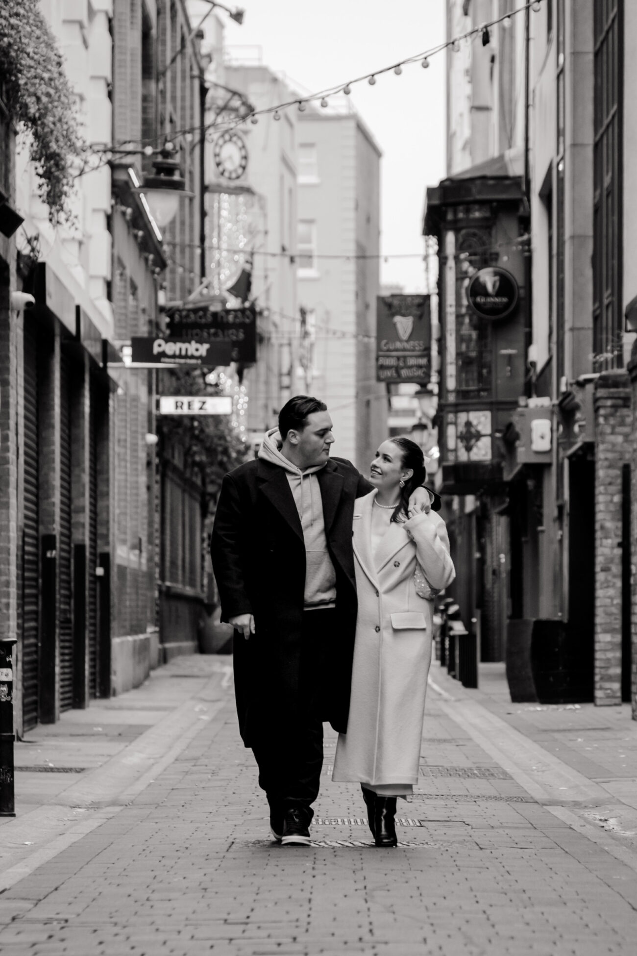 Couple walking down a small street in Dublin looking at each other