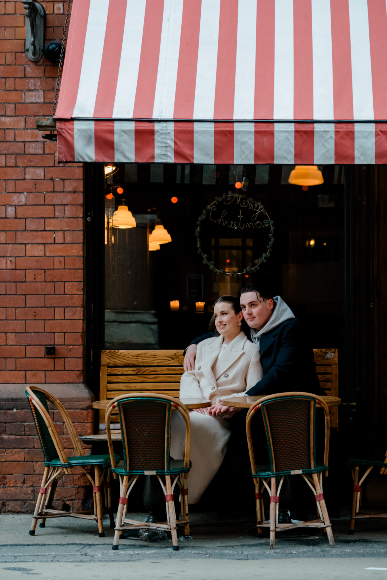 couple sitting outside a cafe in Dublin, cuddling up