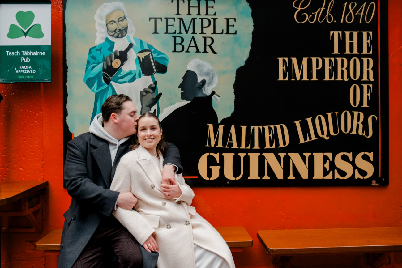 Couple sitting outside The Temple Bar pub in Dublin