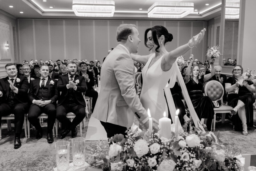 bride going to hug her husband for their first kiss at ceremony in Johnstown House, candid wedding ceremony photo