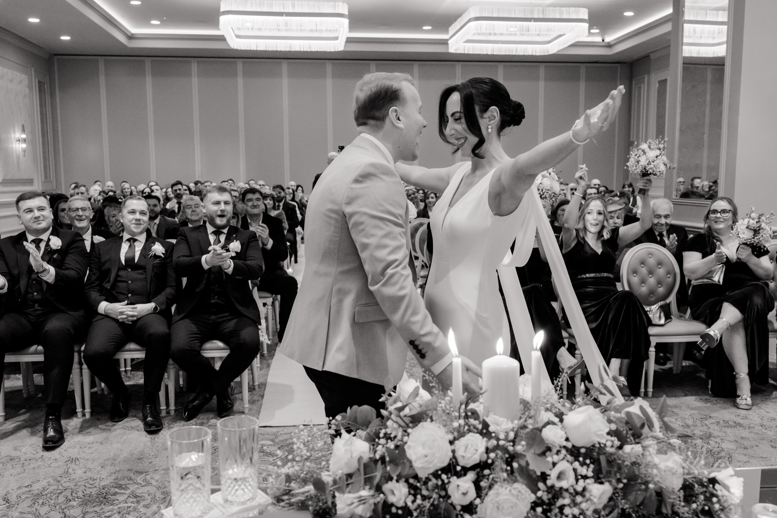 bride going to hug her husband for their first kiss at ceremony in Johnstown House, candid wedding ceremony photo