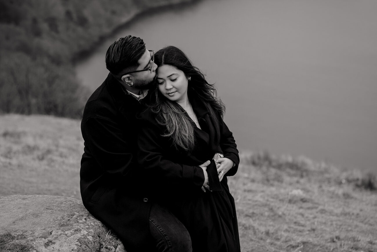 couple embracing after a secret proposal in Lough Tay