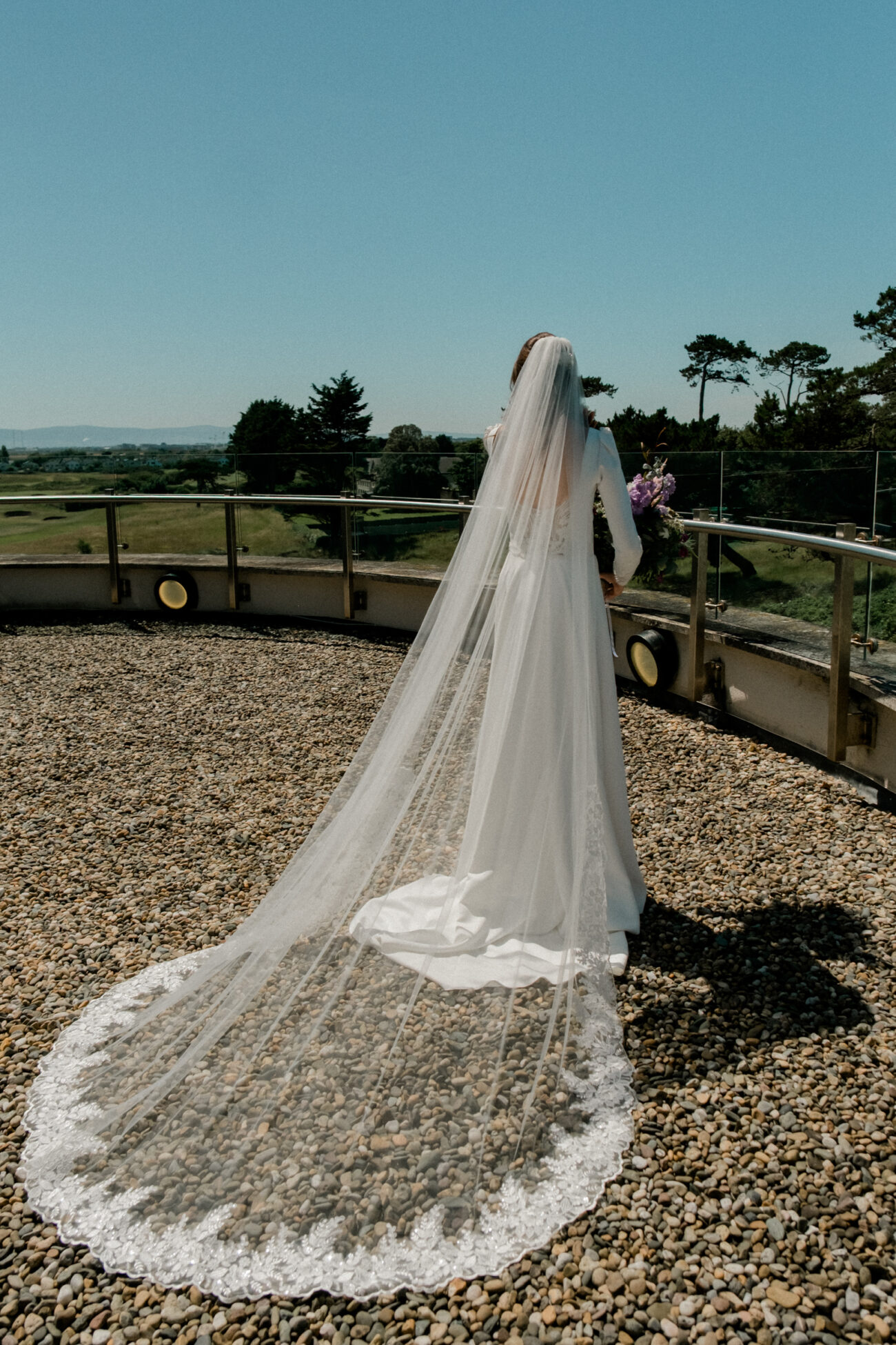 Bride on the balcony during bridal prep at Portmarnock Resort
