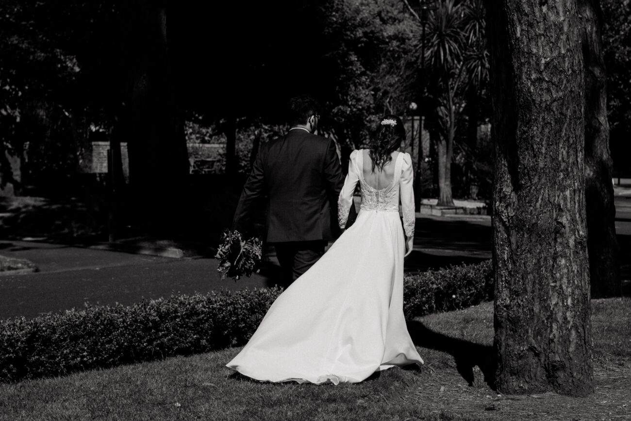 bride and groom walking through the gardens at Portmarnock Resort