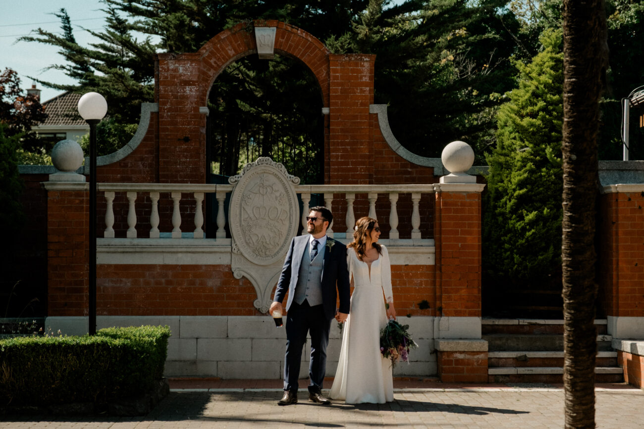 Bride and groom at the monument in Portmarnock Resort