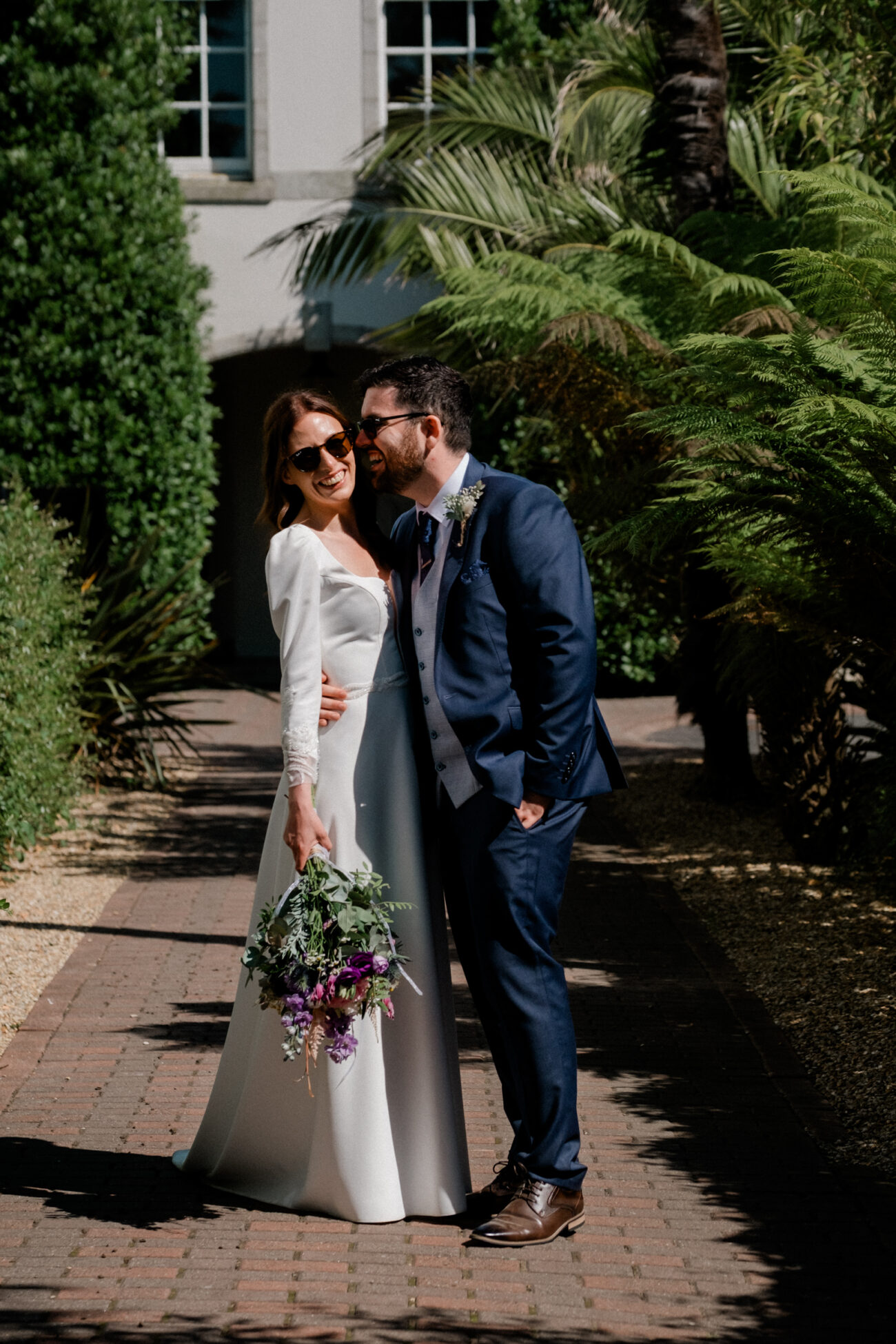 groom kissing the bride in the gardens of Portmarnock Resort