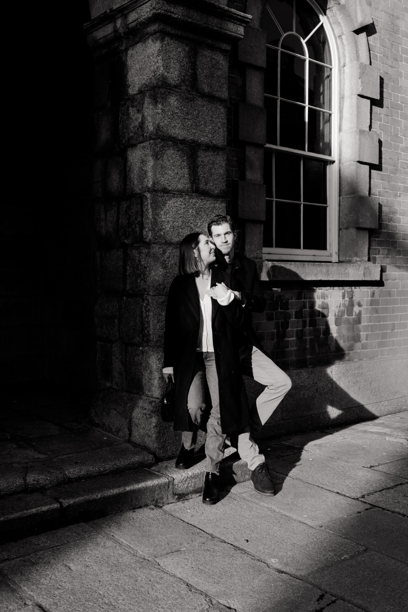couple standing on the stone walls at Dublin Castle