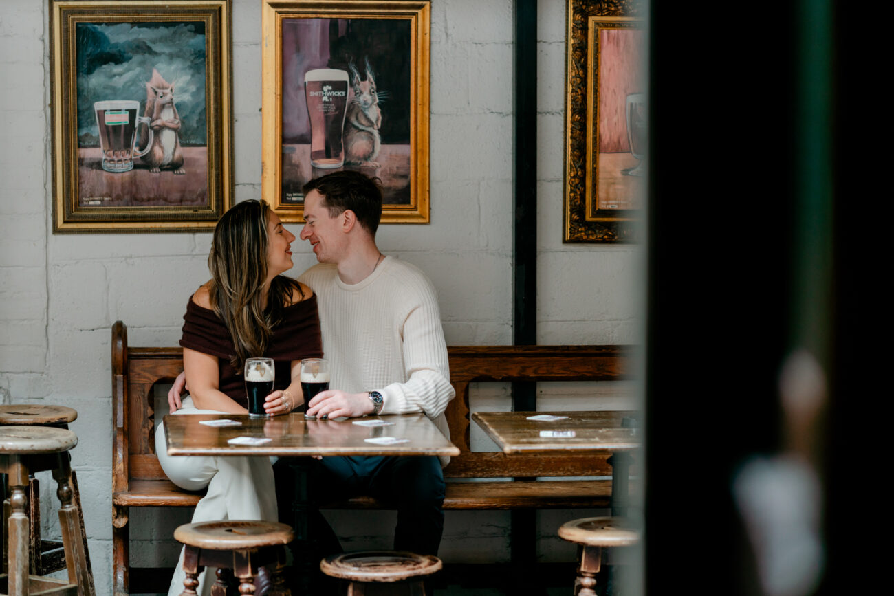 Couple sitting and drinking Guinness at an engagement shoot in Dublin City